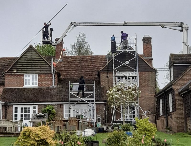 The Moss Cleaners using cherry picker and scaffolding to clean roof safely and professionally in Tidworth, Wiltshire